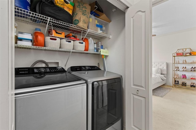 laundry area with washer and dryer, laundry area, and carpet