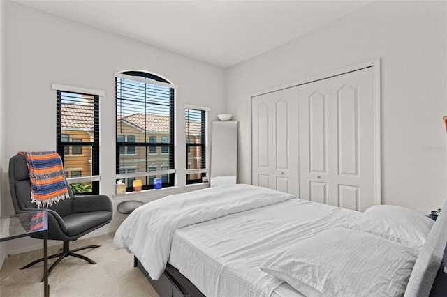 carpeted bedroom featuring a closet