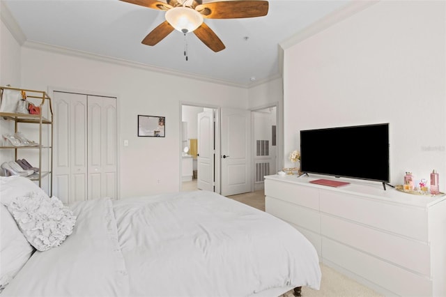 bedroom featuring a closet, ornamental molding, a ceiling fan, and light colored carpet