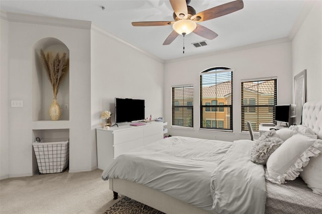 bedroom with carpet floors, a ceiling fan, visible vents, and crown molding