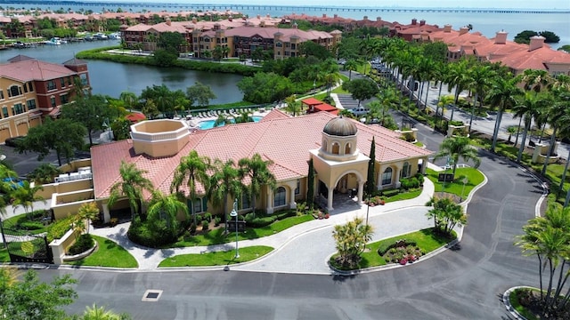 drone / aerial view with a water view and a residential view