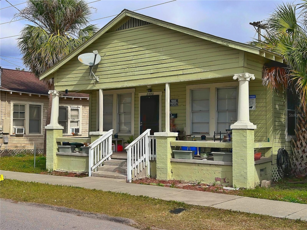 view of front of property featuring cooling unit and covered porch