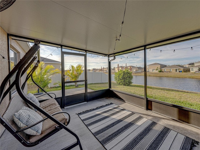 unfurnished sunroom featuring a water view