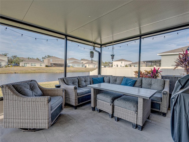 sunroom / solarium with a water view