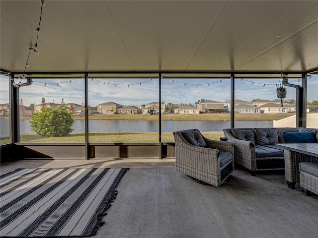 unfurnished sunroom with a wealth of natural light and a water view