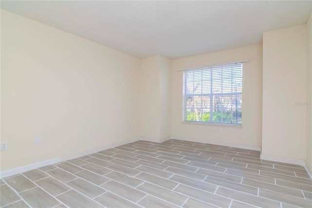 unfurnished room featuring a textured ceiling