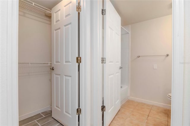 bathroom featuring toilet and separate shower and tub