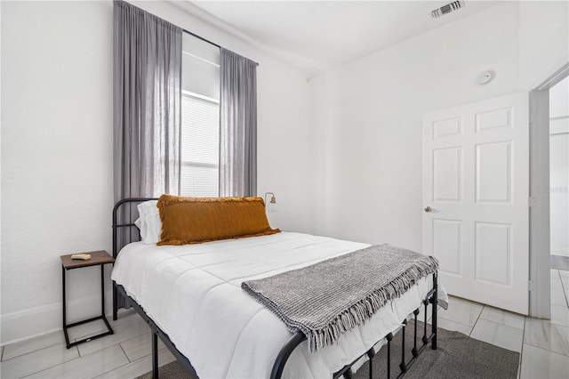 bedroom featuring light tile patterned floors