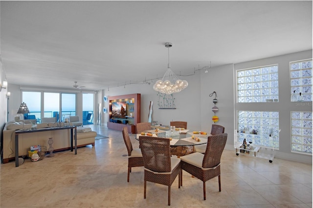 tiled dining area with an inviting chandelier and track lighting