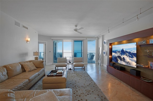 living room featuring rail lighting and ceiling fan