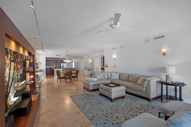 living room featuring ceiling fan with notable chandelier and track lighting