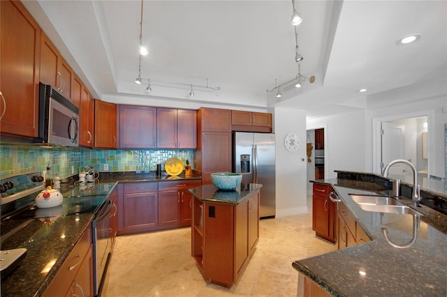 kitchen featuring tasteful backsplash, sink, hanging light fixtures, a center island, and stainless steel appliances