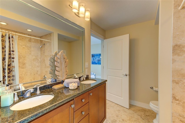 bathroom featuring walk in shower, vanity, and toilet