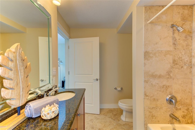 full bathroom with vanity, toilet, and tiled shower / bath combo