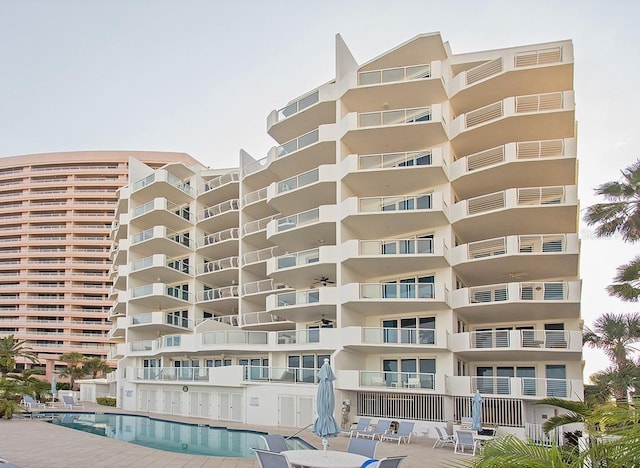 view of building exterior featuring a community pool