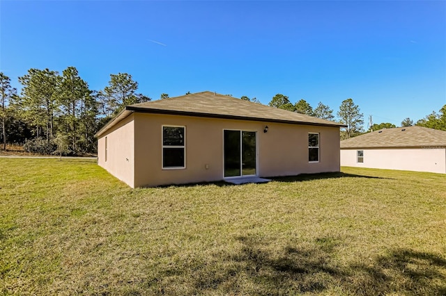 back of property with a lawn