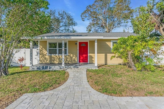 single story home featuring a front yard and covered porch