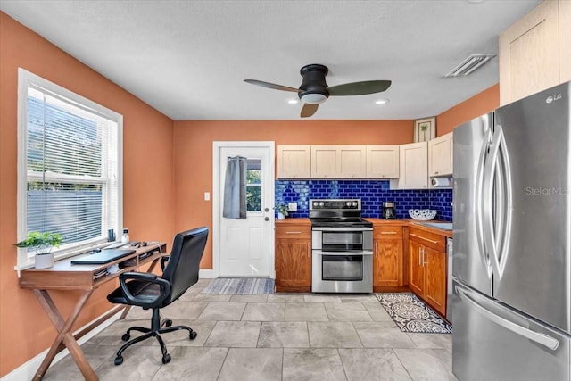 kitchen featuring backsplash, ceiling fan, and appliances with stainless steel finishes