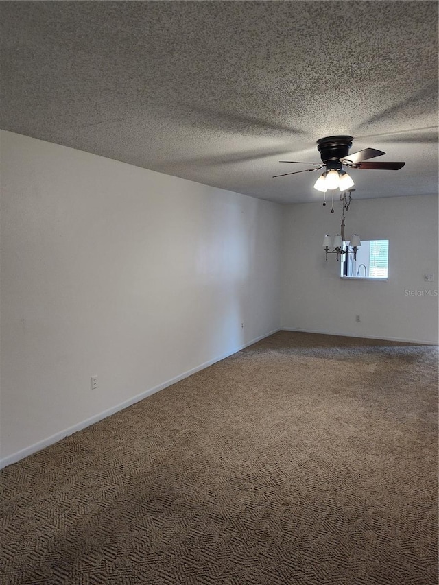 carpeted empty room with ceiling fan and a textured ceiling