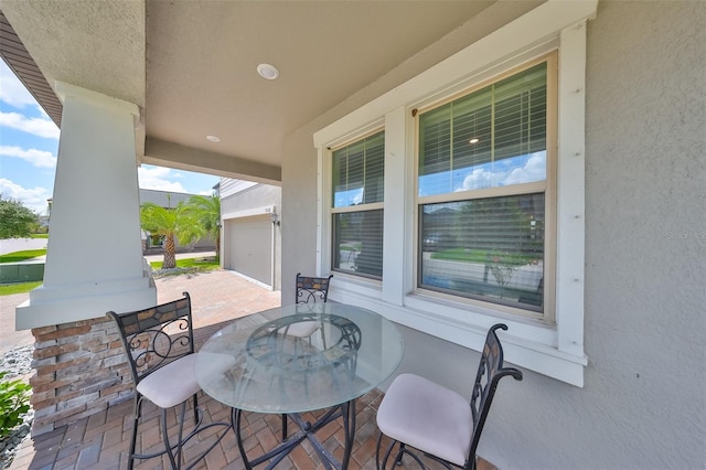 view of patio featuring a porch and a garage