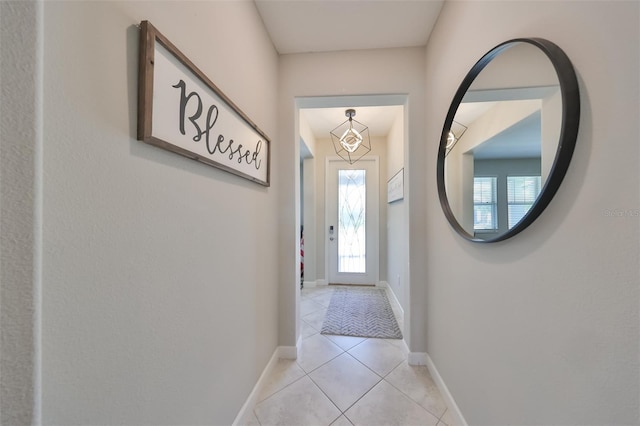 doorway to outside featuring light tile patterned flooring