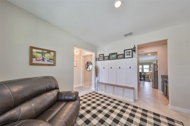 tiled living room with a textured ceiling