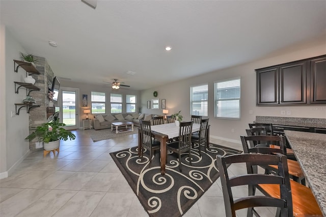 tiled dining space with ceiling fan