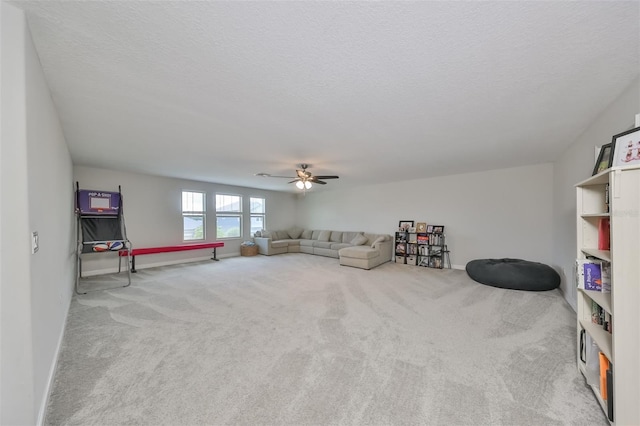 rec room with ceiling fan, a textured ceiling, and carpet flooring