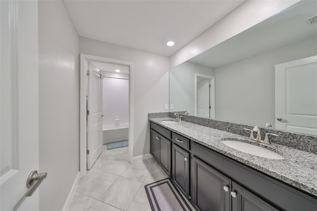 bathroom with vanity, tile patterned floors, and washtub / shower combination