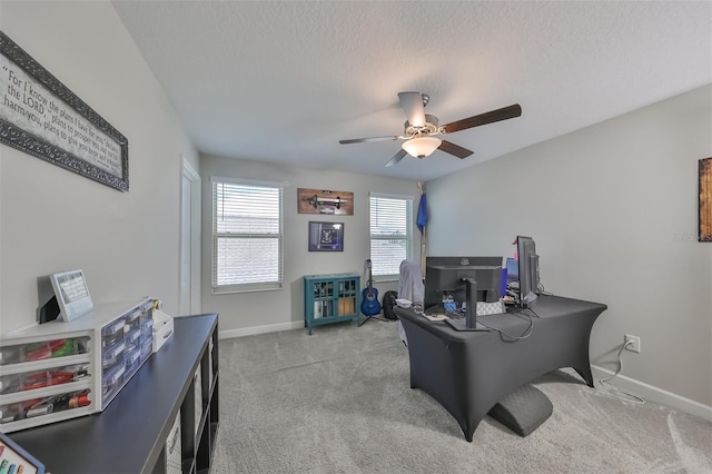 home office with ceiling fan, light colored carpet, and a textured ceiling