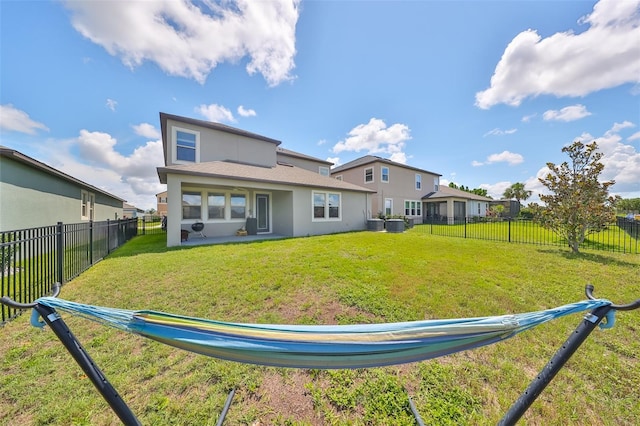 back of property featuring a lawn