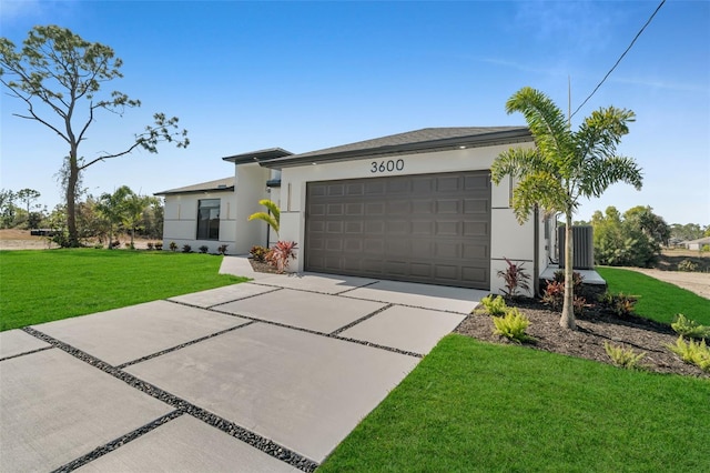 view of front of house featuring an attached garage, concrete driveway, a front yard, and stucco siding