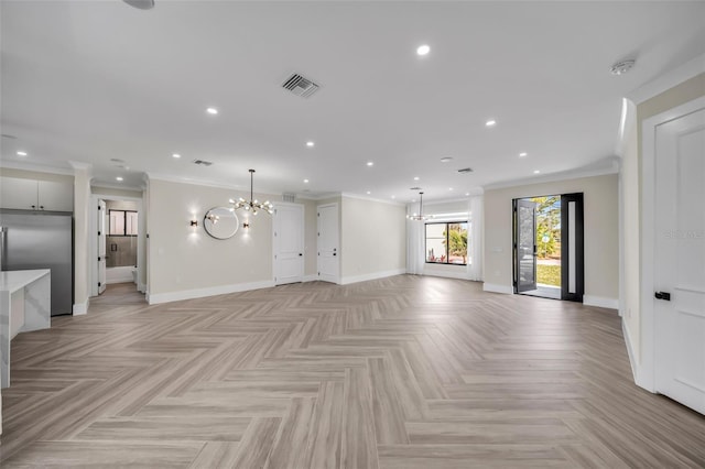 unfurnished living room with an inviting chandelier, crown molding, and light parquet flooring