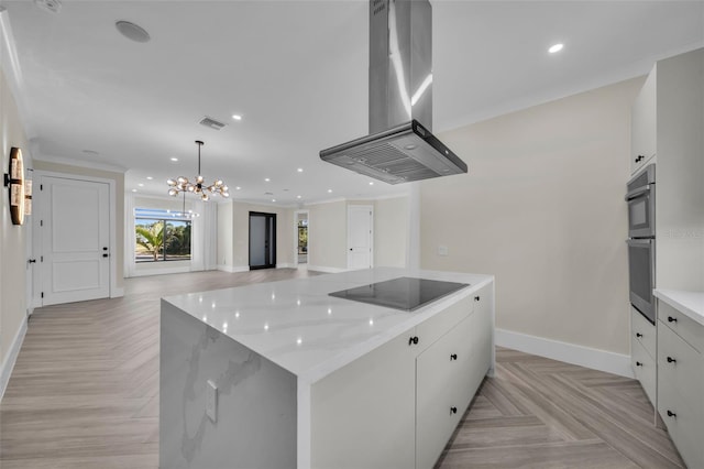 kitchen with white cabinetry, black electric stovetop, island range hood, and light parquet floors