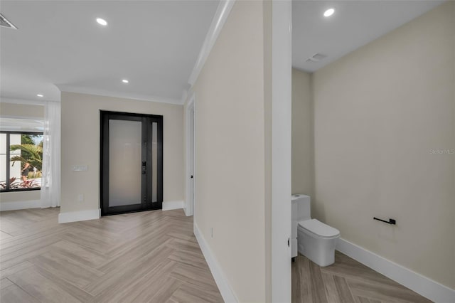 entryway featuring crown molding and light parquet floors