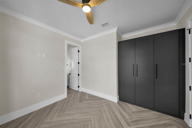 unfurnished bedroom with ornamental molding, a closet, visible vents, and baseboards