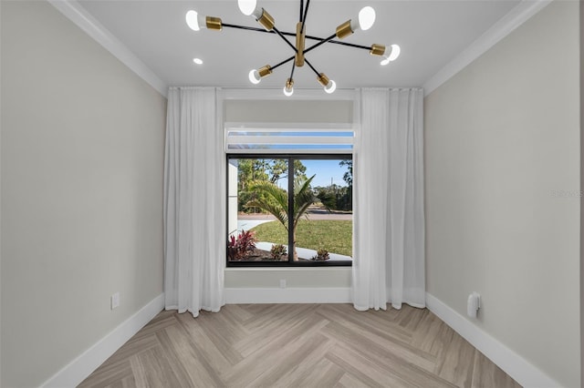 spare room featuring ornamental molding, light parquet flooring, and a chandelier