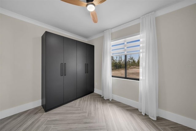 unfurnished bedroom featuring crown molding, ceiling fan, and light parquet floors