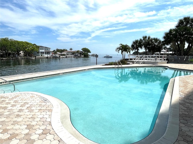 view of swimming pool with a water view