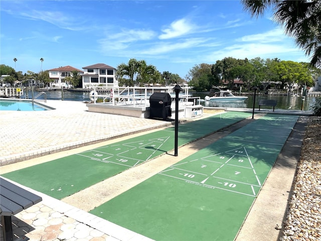 surrounding community featuring a water view and a pool