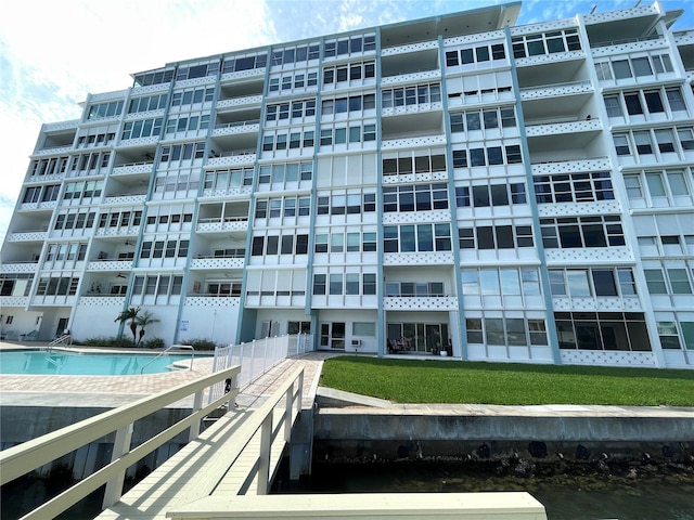 view of property featuring a water view and a community pool