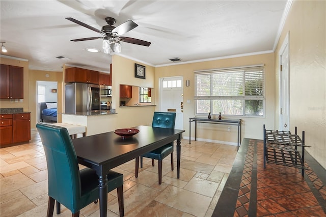 dining space featuring ceiling fan and ornamental molding