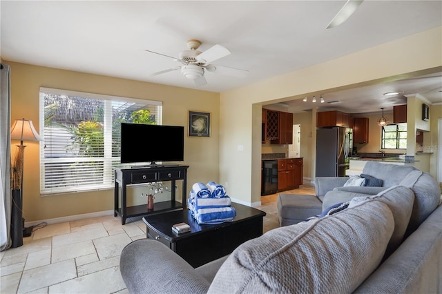 living room with wine cooler, indoor wet bar, and ceiling fan