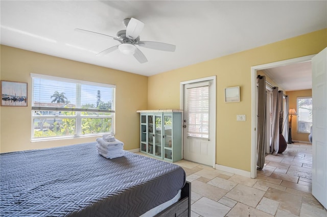 bedroom with a barn door and ceiling fan