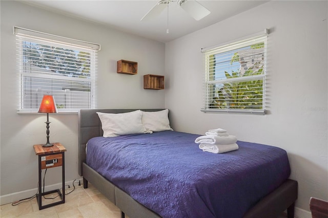 bedroom featuring multiple windows and ceiling fan