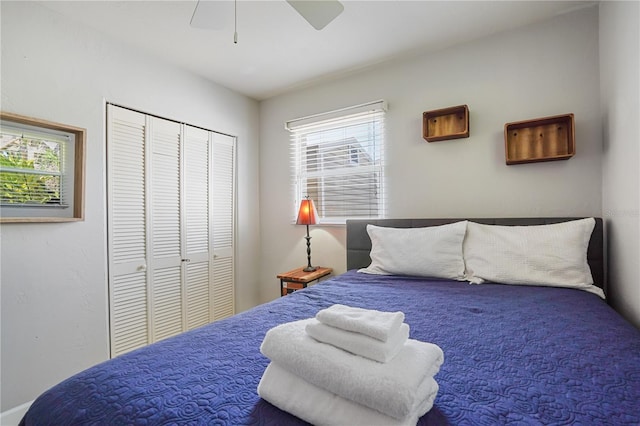 bedroom featuring multiple windows, a closet, and ceiling fan