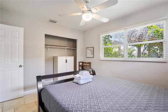 bedroom with ceiling fan and a closet