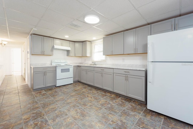 kitchen with white appliances, sink, and gray cabinetry