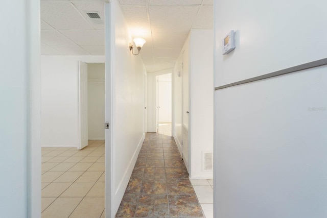 hallway featuring a drop ceiling