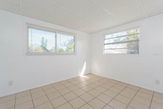 unfurnished room with a drop ceiling